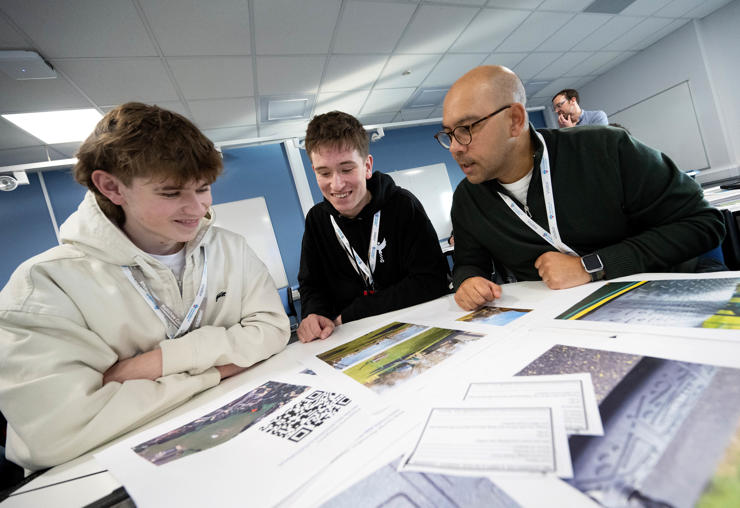 William Smith (left) and another Runshaw College pupil with Alex Murray from BBC Verify learn about DIY reporting on social media.