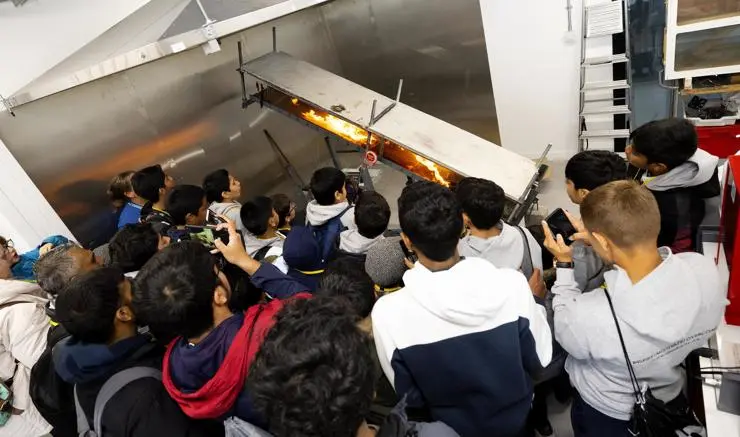 Boys from IMO Charity, in Blackburn, watching a fire experiment