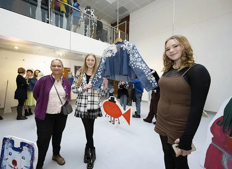Monica Dean and Esmee Backhouse, 14, from Corpus Christi Catholic High School show Lubaina Himid their denim designs.