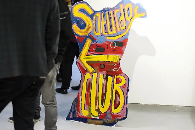 A sign painted by Saturday Club students