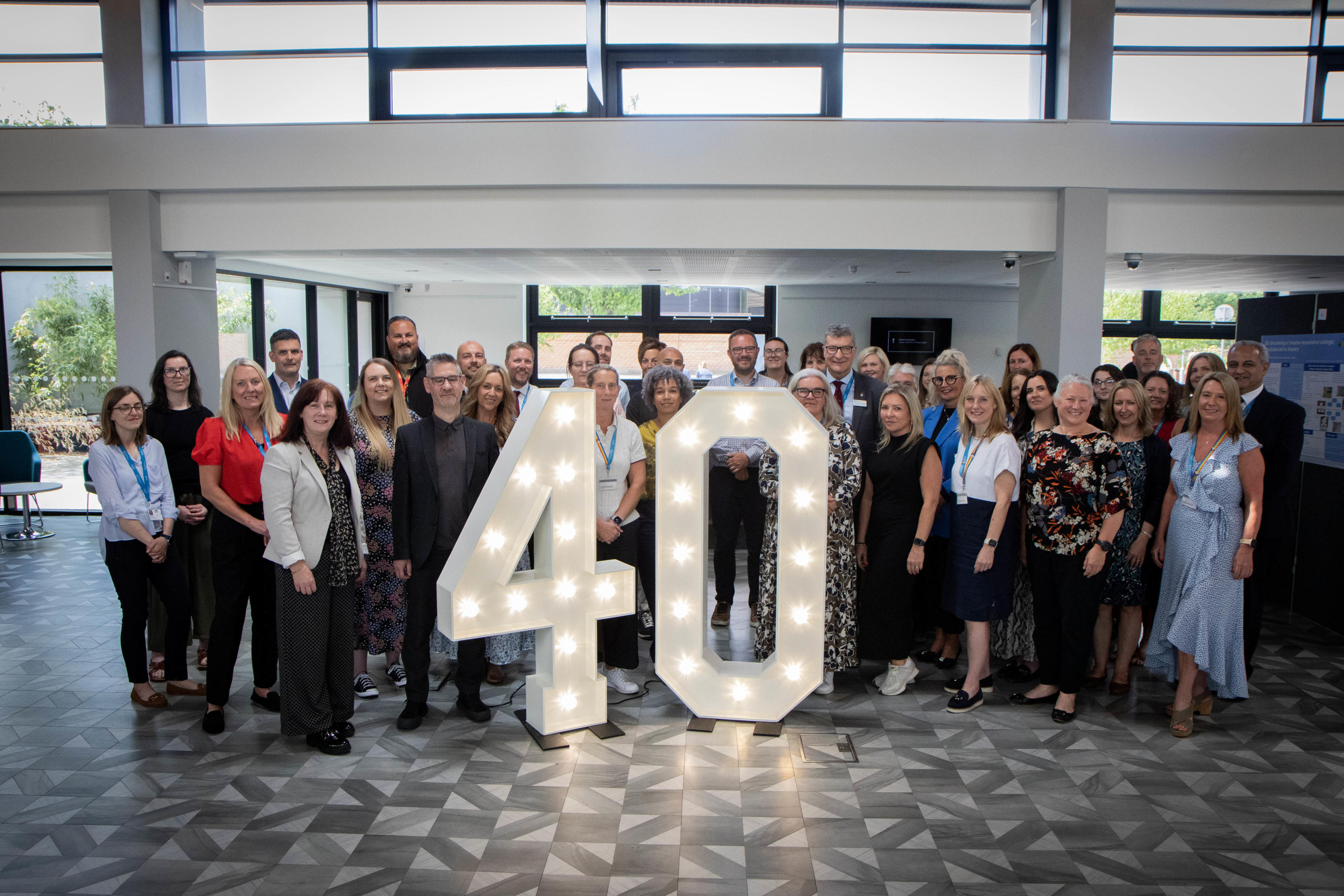 University staff join representatives from its partner colleges to celebrate 40 years of partnership education.