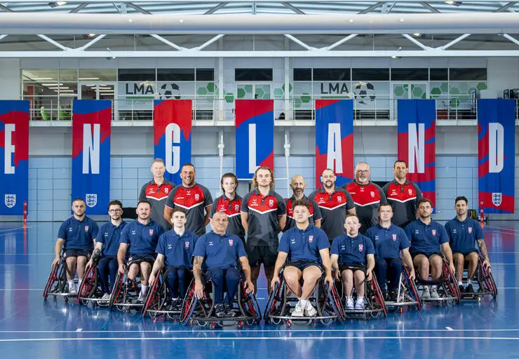 Amelia and Sam stand alongside the coaching team and playerd