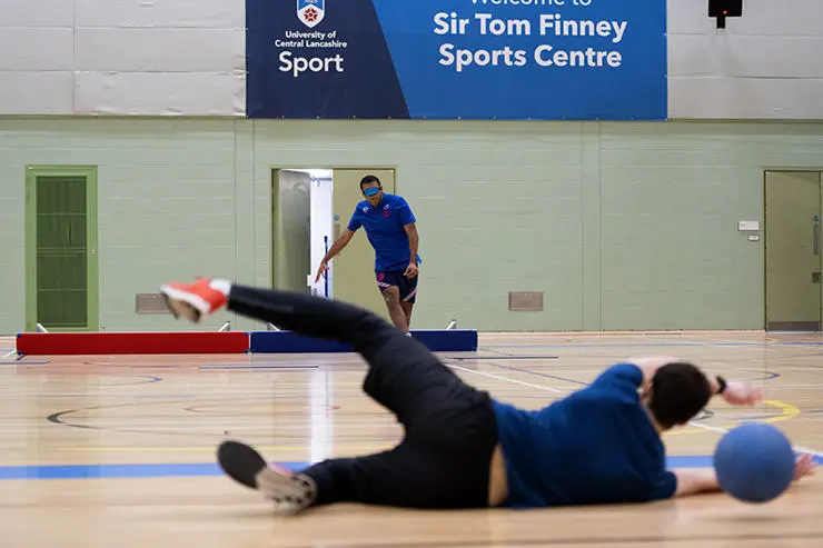 Student Tom Harris dives to save the ball