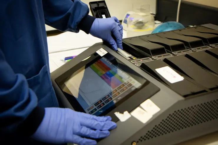 Research assistant Mariana Moreira adding samples to the test reader