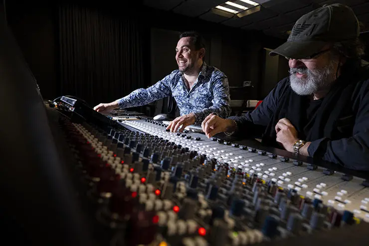 UCLan MA Music Industry Management and Promotion student Paul Wolski (left) with Anthony King, who worked on the song’s orchestral arrangements, piano, keyboards, organs and bass, at a mixing desk in UCLan’s Media Factory.