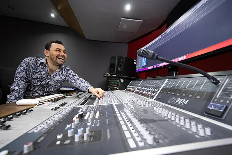 UCLan MA Music Industry Management and Promotion student Paul Wolski at a mixing desk in UCLan’s Media Factory.