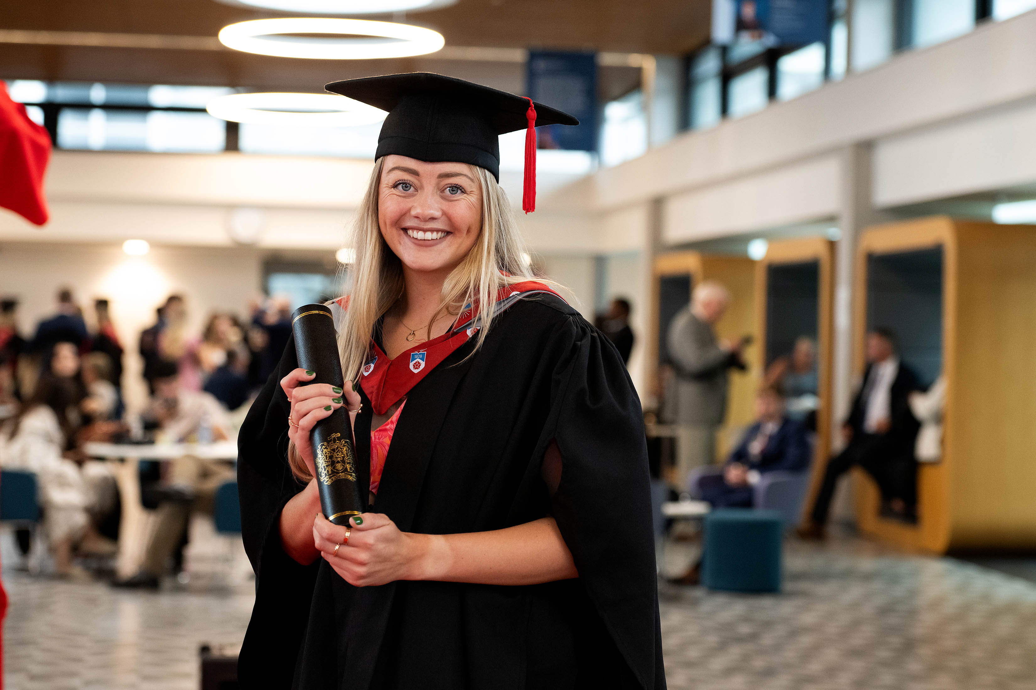Ashleigh Abbott smiling and holding a scroll