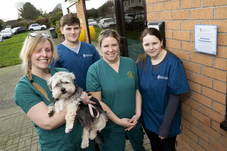 Katey Middleton holding Ernie the dog, with Dylan Fowles, Kate Flintoft and Lucy Storey