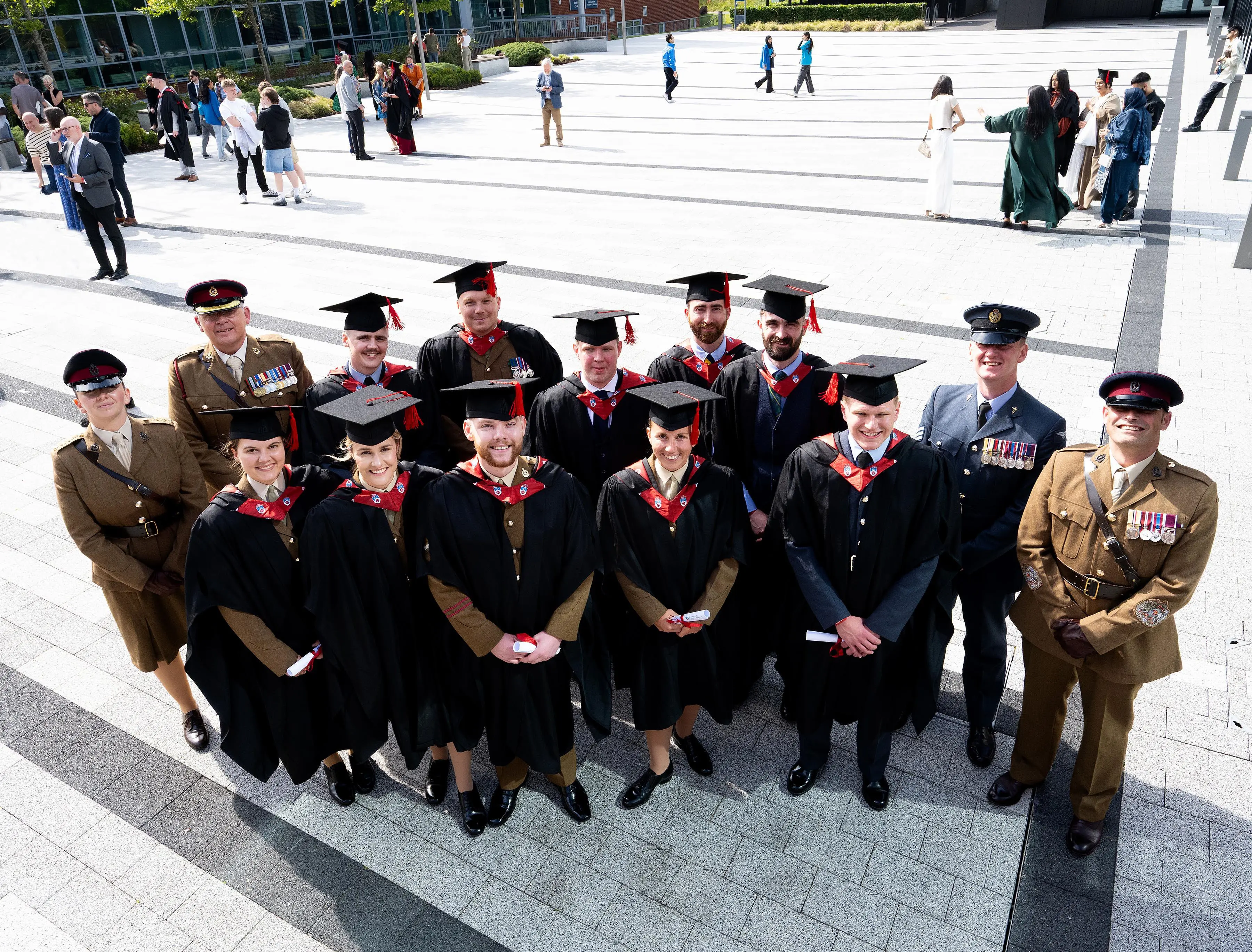 A group of military paramedics in academic caps and gowns