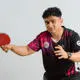 Murhad Hussain holding a table tennis bat in his hand