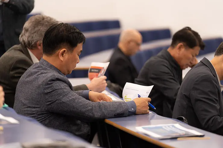 South Korean delegates at the conference, making notes