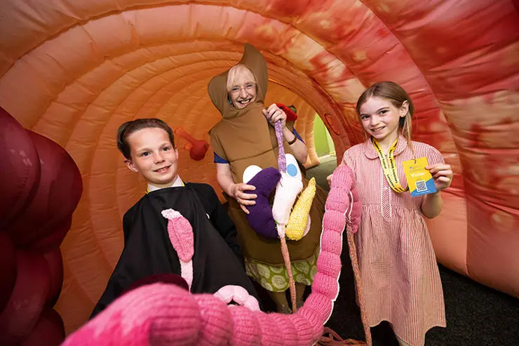 (L-R) Dylan Geynor from Unity Primary, Julie Thompson, Information Manager from Guts UK and Kacey Turner, 10, from Unity Primary in Colin the Colon