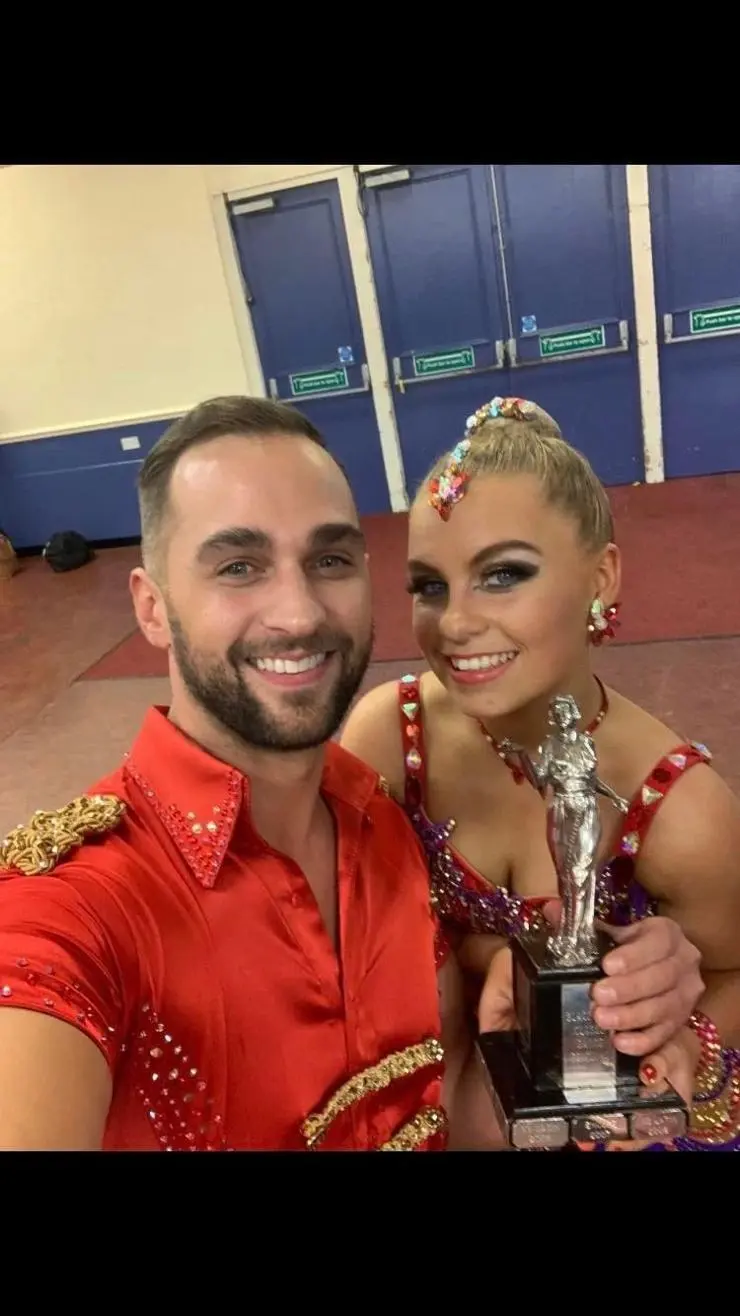 Chloe pictured with her dance partner Luke Taberer and their dance trophy 