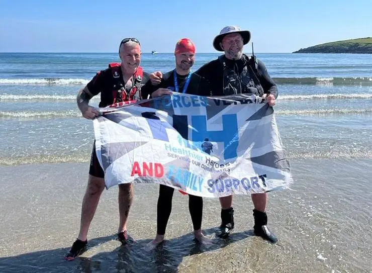 Adam, in the centre, with two of his support crew