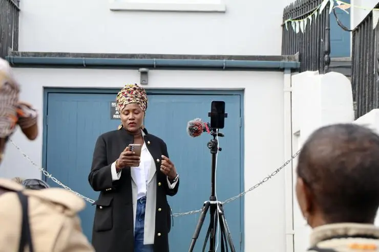 Guilaine Brutus of the Haitian Heritage Group speaking at the unveiling ceremony