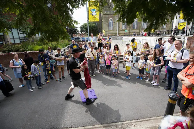 Crowds gather around one of the outdoor performers
