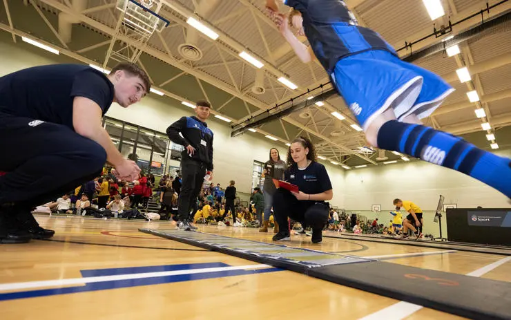 A schoolboy taking part in the triple jump