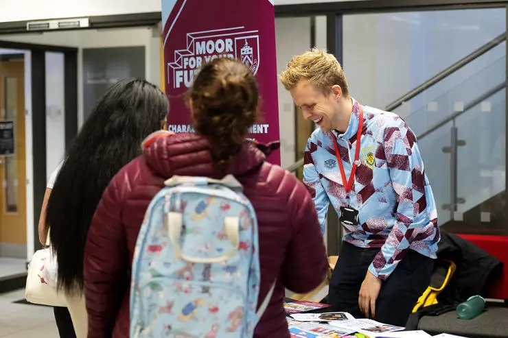 Students at the Burnley Football Club stand