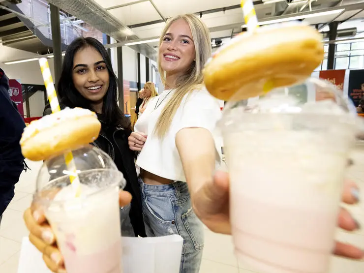 Two students showing some of the sweet treats which were available